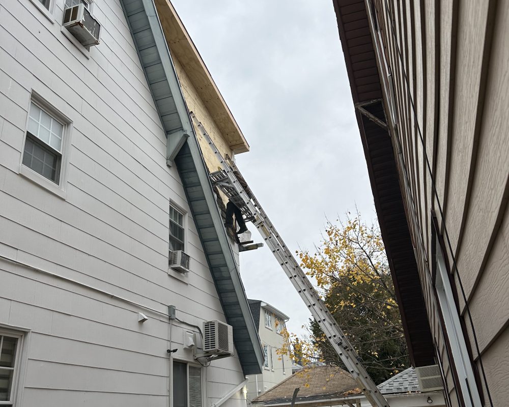 Completed home exterior with new siding and windows